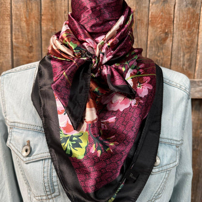Floral scarf tied around a person's head with a denim jacket in the background