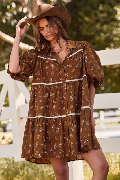 Woman wearing a brown patterned dress and hat outdoors